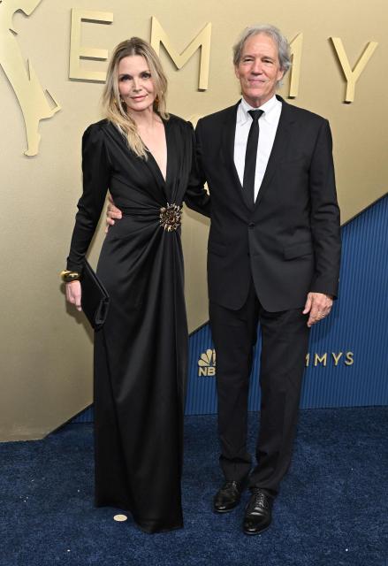 US actress Michelle Pfeiffer and her husband writer David E. Kelley arrive for the 78th Primetime Emmy Awards at the Peacock Theatre at LA Live in Los Angeles on September 14, 2026. (Photo by LISA O'CONNOR / AFP)