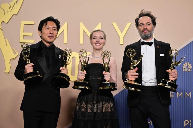 (From L) Japanese-US filmmaker Hiro Murai winner of the award for Outstanding Directing for a Comedy Seriesfor "Welcome to Widow's Bay" episode from "Widow's Bay", US screenwriter Katie Dippold winner of Outstanding Writing for a Comedy Series for "Widow's Bay" and Welsh actor Matthew Rhys winner of the awards for Outstanding Lead Actor in a Comedy Series for "Widow's Bay" pose in the press room during the 78th Primetime Emmy Awards at the Peacock Theatre at LA Live in Los Angeles on September 14, 2026. (Photo by Frederic J. Brown / AFP)