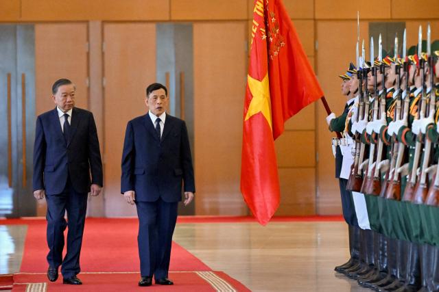 Vietnam's President To Lam (L) and Thailand's King Maha Vajiralongkorn review honour guards during a welcome ceremony at the National Assembly House in Hanoi on September 15, 2026. (Photo by Nhac NGUYEN / AFP)