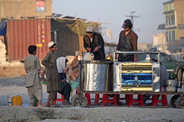 An Afghan man prepares breakfast at a stall along a street in Spin Boldak district of Afghanistan's Kandahar province on September 15, 2026. (Photo by Sanaullah SEIAM / AFP)