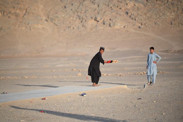 Afghan boys play cricket along a street in Spin Boldak district of Afghanistan's Kandahar province on September 15, 2026. (Photo by Sanaullah SEIAM / AFP)