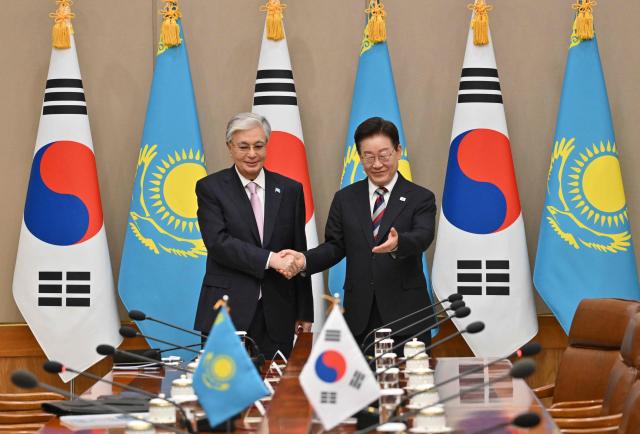 Kazakhstan's President Kassym-Jomart Tokayev (L) shakes hands with South Korea's President Lee Jae Myung (R) during their meeting at the presidential Blue House in Seoul on September 15, 2026, on the sidelines of the First Korea-Central Asia Summit 2026. (Photo by JUNG YEON-JE / POOL / AFP)