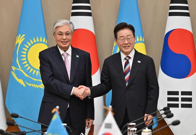 Kazakhstan's President Kassym-Jomart Tokayev (L) shakes hands with South Korea's President Lee Jae Myung (R) during their meeting at the presidential Blue House in Seoul on September 15, 2026, on the sidelines of the First Korea-Central Asia Summit 2026. (Photo by JUNG YEON-JE / POOL / AFP)