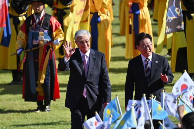 Kazakhstan's President Kassym-Jomart Tokayev (L) and South Korea's President Lee Jae Myung (R) attend a welcoming ceremony at the presidential Blue House in Seoul on September 15, 2026, on the sidelines of the First Korea-Central Asia Summit 2026. (Photo by JUNG YEON-JE / POOL / AFP)