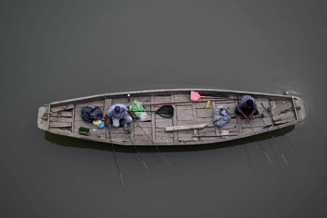 People fish in river Jhelum in Srinagar on September 15, 2026. (Photo by TAUSEEF MUSTAFA / AFP)