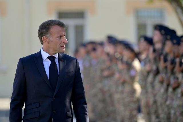 France's President Emmanuel Macron reviews a guard of honour at the start of a visit to the French Army's 155th Air Base, in Orange, southeastern France, on September 15, 2026. (Photo by Philippe Magoni / POOL / AFP)