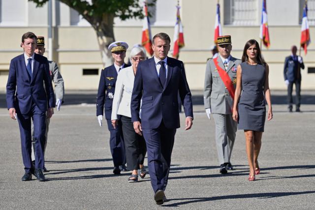 France's President Emmanuel Macron (front), France's Education Minister Edouard Geffray (L), France's Defence Minister Catherine Vautrin (4th L), and France's junior Minister for Veterans affairs Alice Rufo (R) arrive at the start of a visit to the French Army's 155th Air Base, in Orange, southeastern France, on September 15, 2026. (Photo by Philippe Magoni / POOL / AFP)