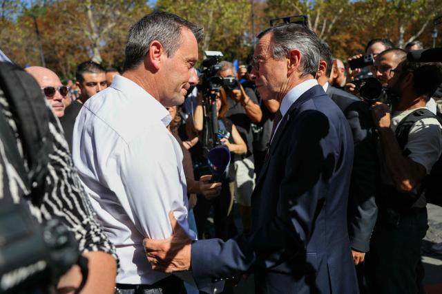 Alliance's national secretary Fabien Vanhemelryck (L) greets right wing party Les Republicains (LR) candidate in France's 2027 presidential election Bruno Retailleau during a demonstration at the call of French union Alliance Police Nationale demanding pay increases, more resources and greater recognition in Paris on September 15, 2025. (Photo by Thomas SAMSON / AFP)