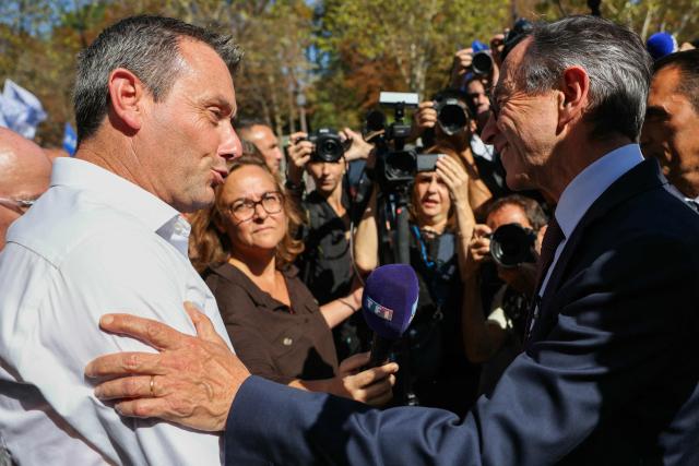 Alliance's national secretary Fabien Vanhemelryck (L) greets right wing party Les Republicains (LR) candidate in France's 2027 presidential election Bruno Retailleau during a demonstration at the call of French union Alliance Police Nationale demanding pay increases, more resources and greater recognition in Paris on September 15, 2025. (Photo by Thomas SAMSON / AFP)