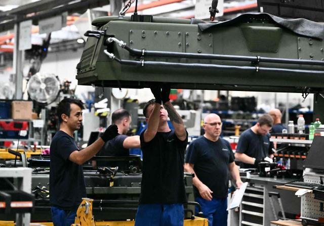 Employee works at a production line of military vehicles during a visit of the Austrian Chancellor at the Rheinmetall MAN Military Vehicles (RMMV) plant in Vienna-Liesing, Austria, on September 15, 2026. (Photo by Joe Klamar / AFP)