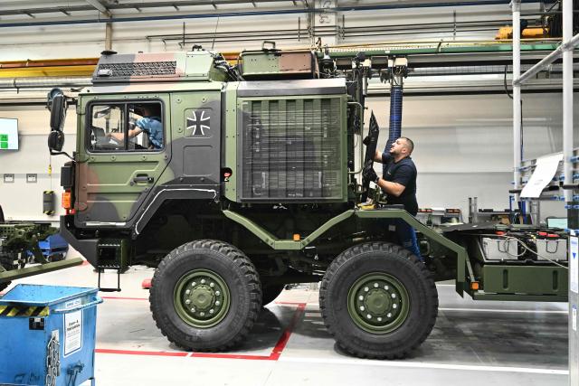 An employee works at a production line of military vehicles during a visit of the Austrian Chancellor at the Rheinmetall MAN Military Vehicles (RMMV) plant in Vienna-Liesing, Austria, on September 15, 2026. The Rheinmetall MAN Military Vehicles (RMMV) plant in Vienna is the biggest manufacturer of military vehicles in Europe. (Photo by Joe Klamar / AFP)