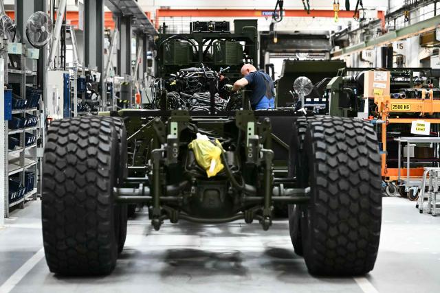 An employee works at a heavy duty transporter at a production line during a visit of the Austrian Chancellor at the Rheinmetall MAN Military Vehicles (RMMV) plant in Vienna-Liesing, Austria, on September 15, 2026. The Rheinmetall MAN Military Vehicles (RMMV) plant in Vienna is the biggest manufacturer of military vehicles in Europe. (Photo by Joe Klamar / AFP)