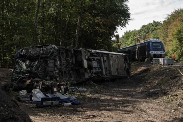 This photograph shows the derailled locomotive (L) during the beginning of the lifting opérations of the derailled train in Cléon, northwestern France, on September 15, 2026. After a TER train derailed in Normandy, injuring 44 people, the authorities are continuing to urge caution regarding the causes of the accident, which are fuelling widespread speculation, as the presence of a piece of rail on the tracks remains unexplained at this stage. (Photo by GUILLAUME SALIGOT / AFP)