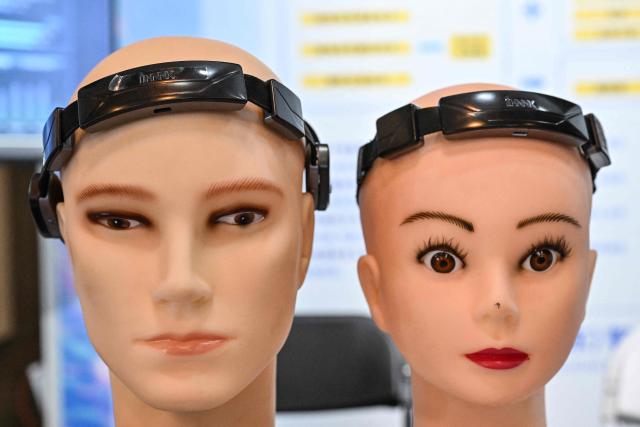 This picture shows brain-computer smart mouse headbands displayed on dummy heads during the 14th China International Defence Electronics Exhibition (CIDEX) in Beijing on September 15, 2026. (Photo by ADEK BERRY / AFP)