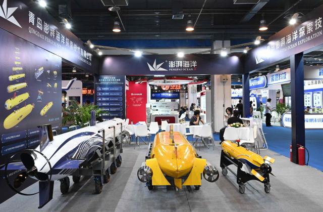 This picture shows autonomous underwater vehicles produced by Qingdao Pengpai Ocean company during the 14th China International Defence Electronics Exhibition (CIDEX) in Beijing on September 15, 2026. (Photo by ADEK BERRY / AFP)