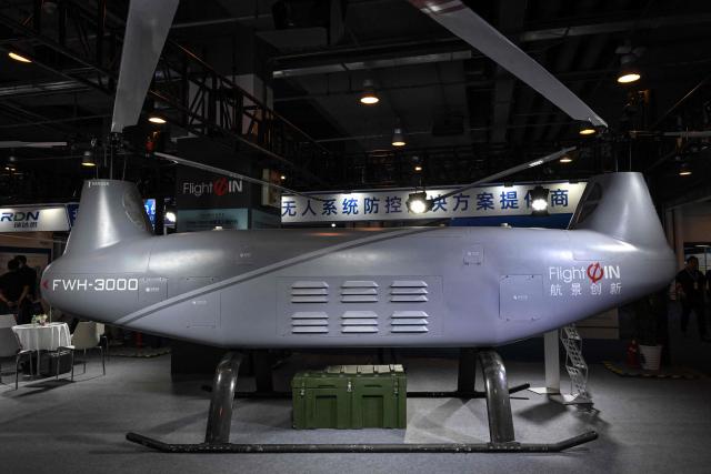 The FWH-3000 tandem unmanned helicopter produced by Hangjing Chuangxin company is pictured during the 14th China International Defence Electronics Exhibition (CIDEX) in Beijing on September 15, 2026. (Photo by ADEK BERRY / AFP)