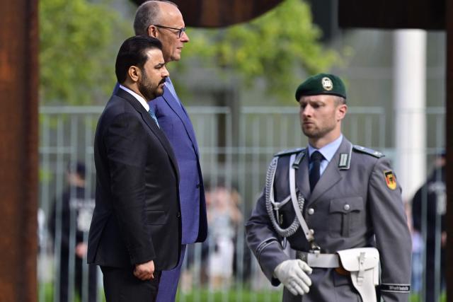 German Chancellor Friedrich Merz (2L) and Iraq's Prime Minister Ali Falih Kadhim al-Zaidi listen to the national anthems during a welcome ceremony on September 15, 2026 at the Chancellery in Berlin. (Photo by John MACDOUGALL / AFP)