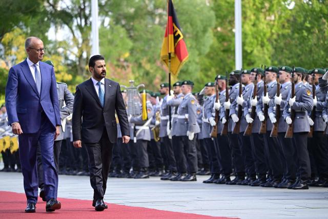 German Chancellor Friedrich Merz (L) and Iraq's Prime Minister Ali Falih Kadhim al-Zaidi review a military honor guard on September 15, 2026 at the courtyard of the Chancellery in Berlin. (Photo by John MACDOUGALL / AFP)