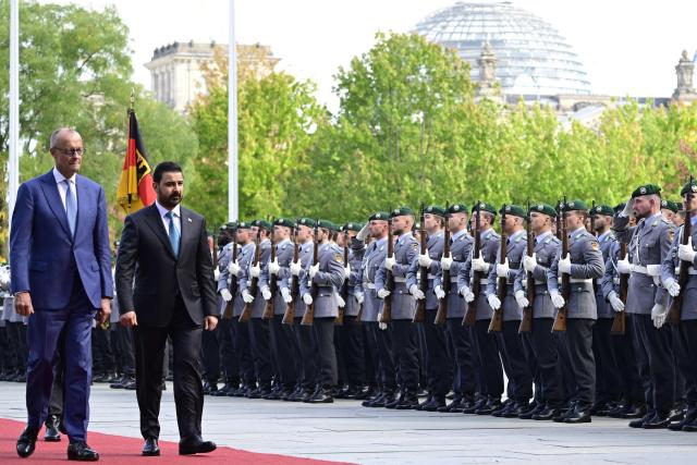 German Chancellor Friedrich Merz (L) and Iraq's Prime Minister Ali Falih Kadhim al-Zaidi review a military honor guard on September 15, 2026 at the courtyard of the Chancellery in Berlin. (Photo by John MACDOUGALL / AFP)
