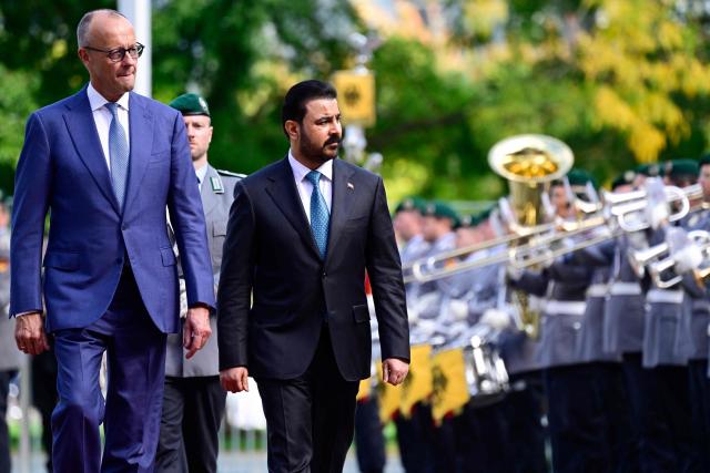 German Chancellor Friedrich Merz (L) and Iraq's Prime Minister Ali al-Zaidi review an honour guard during a welcoming ceremony on September 15, 2026 at the Chancellery in Berlin prior talks. (Photo by John MACDOUGALL / AFP)