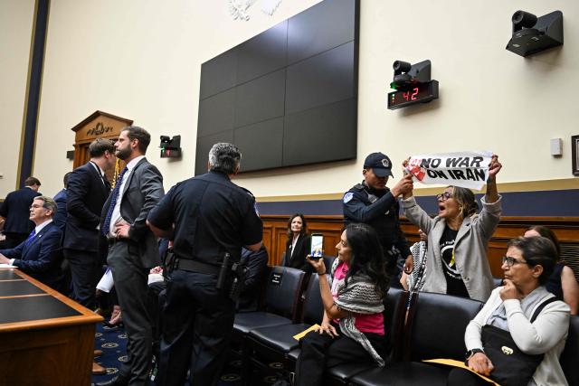 A demonstrator (R) protesting the war in Iran is removed by Capitol Police officers as US Treasury Secretary Scott Bessent (L) testifies during a House Financial Services Committee hearing on the state of the international financial system on Capitol Hill in Washington, DC, on September 15, 2026. (Photo by ROBERTO SCHMIDT / AFP)