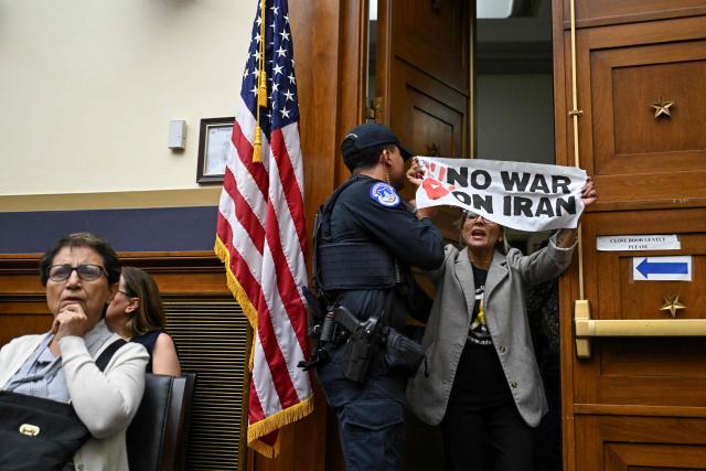 A demonstrator protesting the war in Iran is removed by a Capitol Police officer as US Treasury Secretary Scott Bessent (out of frame) testifies during a House Financial Services Committee hearing on the state of the international financial system on Capitol Hill in Washington, DC, on September 15, 2026. (Photo by ROBERTO SCHMIDT / AFP)