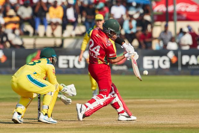Zimbabwe's Sikandar Raza (R) plays a shot as Australia's wicket keeper Josh Inglis looks on during the first One Day International series played between hosts Zimbabwe and  Australia at Harare Sports Club on September 15, 2026 in Harare. (Photo by Jekesai NJIKIZANA / AFP)
