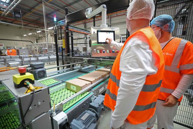 Danone employees work on the production lines at the company's plant in Steenvoorde on the inauguration day of Danone's largest medical nutrition line in France, on September 15, 2026. (Photo by Francois LO PRESTI / AFP)