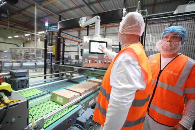 Danone employees work on the production lines at the company's plant in Steenvoorde on the inauguration day of Danone's largest medical nutrition line in France, on September 15, 2026. (Photo by Francois LO PRESTI / AFP)