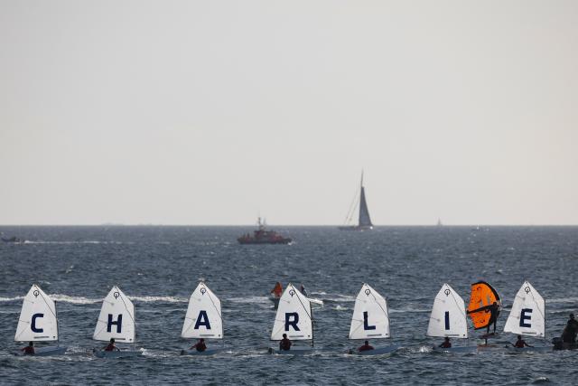 Sail boat sail in formation to display the name "Charlie" as part of a maritime tribute to the late sailor Charlie Dalin, in Concarneau, in Brittany, western France on September 15, 2026. French offshore sailor and Vendee Globe 2024/2025 winner Charlie Dalin has died in Quimper, western France, aged 42, from cancer, his family announced on June 11, 2026. (Photo by FRED TANNEAU / AFP)