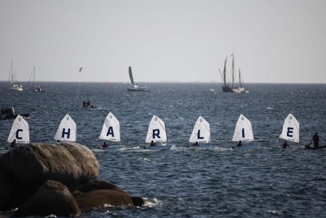 Sail boat sail in formation to display the name "Charlie" as part of a maritime tribute to the late sailor Charlie Dalin, in Concarneau, in Brittany, western France on September 15, 2026. French offshore sailor and Vendee Globe 2024/2025 winner Charlie Dalin has died in Quimper, western France, aged 42, from cancer, his family announced on June 11, 2026. (Photo by FRED TANNEAU / AFP)