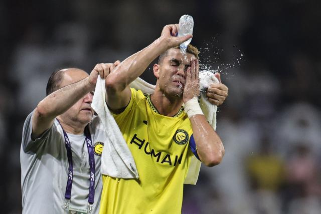 Nassr's Portuguese forward #07 Cristiano Ronaldo splashes water on his face during the AFC Champions League Elite (ACL) football match between Al-Ain and Al-Nassr at the Azza Bin Zayed stadium in Al-Ain on September 15, 2026. (Photo by Fadel SENNA / AFP)