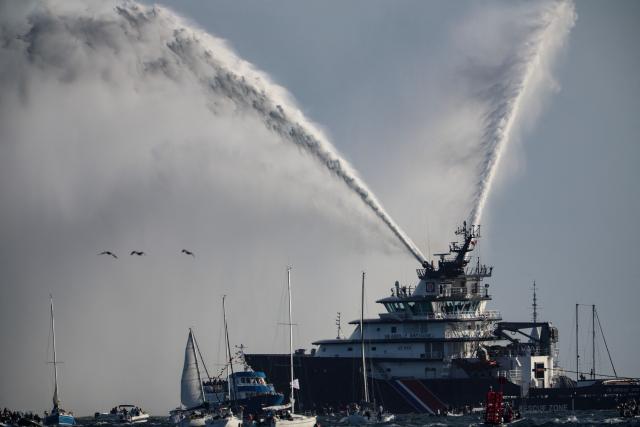 French rescue tugboat Abeille Bretagne sprays water as part of a maritime tribute to the late sailor Charlie Dalin, in Concarneau, in Brittany, western France on September 15, 2026. French offshore sailor and Vendee Globe 2024/2025 winner Charlie Dalin has died in Quimper, western France, aged 42, from cancer, his family announced on June 11, 2026. (Photo by FRED TANNEAU / AFP)