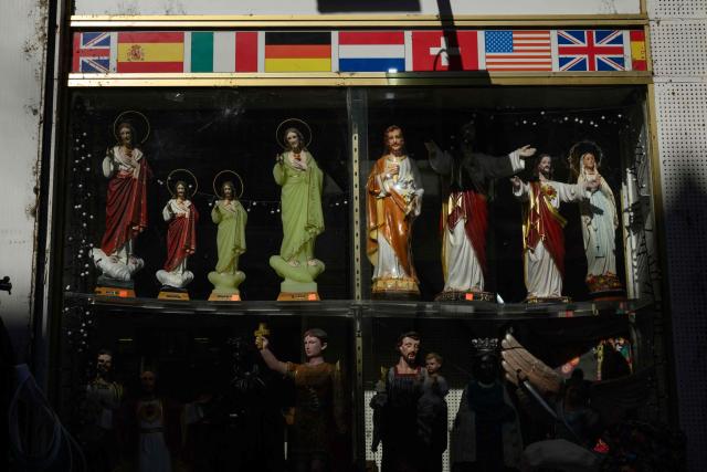 This photograph shows religious statues displayed for sale at a shop in Lourdes on September 15, 2026. Pope Leo XIV will travel to Lourdes, a site of pilgrimage for Christians worldwide, where he will hold an open-air mass on Sunday, September 27, before presiding over another at the cathedral in the northeastern city of Metz on September 28. (Photo by Ed JONES / AFP)