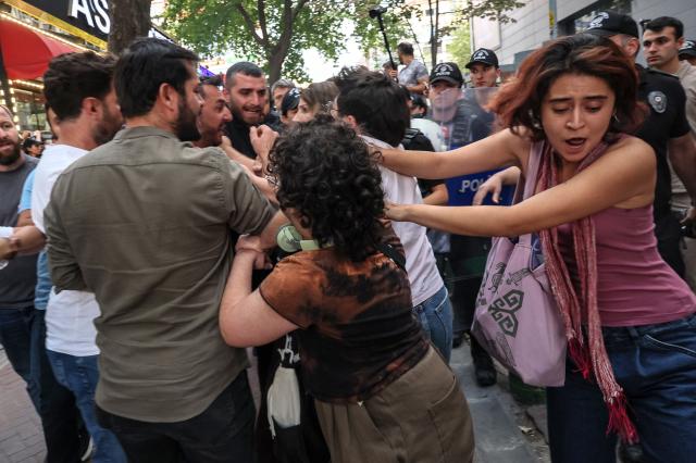 Turkish anti riot police officers clash with protesters during a demonstration against the arrests and growing targeting of LGBTQ activists in Ankara, on September 15, 2026. Turkish police arrested dozens of people on September 13 in gay bars and at the homes of LGBTQ activists on charges including "obscenity", "assisting prostitution" and having "financial links abroad". Authorities have blocked social media accounts belonging to human rights defenders and media outlets as part of operations dubbed "My Family Is Safe. (Photo by Adem ALTAN / AFP)