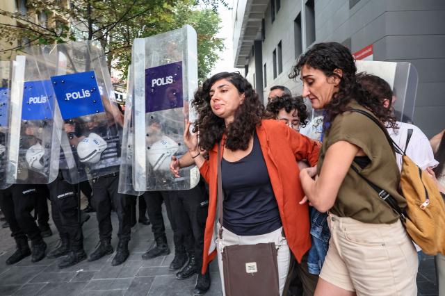 Turkish anti riot police officers push back protesters during a demonstration against the arrests and growing targeting of LGBTQ activists in Ankara, on September 15, 2026. Turkish police arrested dozens of people on September 13 in gay bars and at the homes of LGBTQ activists on charges including "obscenity", "assisting prostitution" and having "financial links abroad". Authorities have blocked social media accounts belonging to human rights defenders and media outlets as part of operations dubbed "My Family Is Safe. (Photo by Adem ALTAN / AFP)