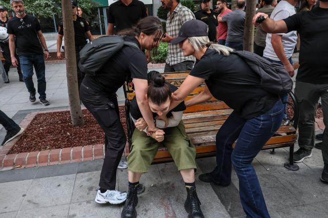 Turkish anti riot police officers attempt to detain a protester during a demonstration against the arrests and growing targeting of LGBTQ activists in Ankara, on September 15, 2026. Turkish police arrested dozens of people on September 13 in gay bars and at the homes of LGBTQ activists on charges including "obscenity", "assisting prostitution" and having "financial links abroad". Authorities have blocked social media accounts belonging to human rights defenders and media outlets as part of operations dubbed "My Family Is Safe. (Photo by Adem ALTAN / AFP)
