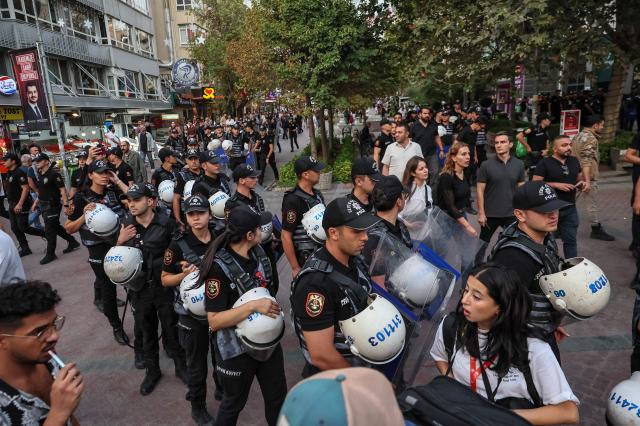 Turkish anti riot police officers are seen during a demonstration against the arrests and growing targeting of LGBTQ activists in Ankara, on September 15, 2026. Turkish police arrested dozens of people on September 13 in gay bars and at the homes of LGBTQ activists on charges including "obscenity", "assisting prostitution" and having "financial links abroad". Authorities have blocked social media accounts belonging to human rights defenders and media outlets as part of operations dubbed "My Family Is Safe. (Photo by Adem ALTAN / AFP)