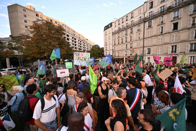 Protestors take part in a demonstration "to say stop to climate austerity" called by a coalition of 53 organizations ahead of political discussions on an upcoming government budget and finance law near Bercy France's Ministry of the Economy in Paris on September 15, 2026. (Photo by LOU BENOIST / AFP)
