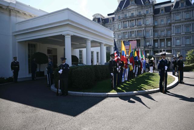 Members of a US military honor guard hold flags as they await the arrival of diplomats ahead of an ambassador credentialing ceremony at the White House in Washington, DC, on September 15, 2026. (Photo by Brendan SMIALOWSKI / AFP)