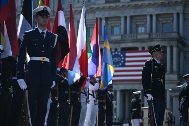 Members of a US military honor guard hold flags as they await the arrival of diplomats ahead of an ambassador credentialing ceremony at the White House in Washington, DC, on September 15, 2026. (Photo by Brendan SMIALOWSKI / AFP)