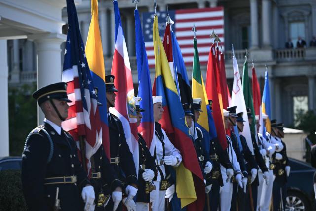 Members of a US military honor guard hold flags as they await the arrival of diplomats ahead of an ambassador credentialing ceremony at the White House in Washington, DC, on September 15, 2026. (Photo by Brendan SMIALOWSKI / AFP)