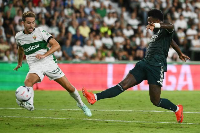 Elche's Spanish defender #06 Pedro Bigas Rigo (L) challenges Real Madrid's Brazilian forward #07 Vinicius Junior during the Spanish league football match between Elche CF and Real Madrid CF at Martinez Valero Stadium in Elche on September 15, 2026. (Photo by JOSE JORDAN / AFP)