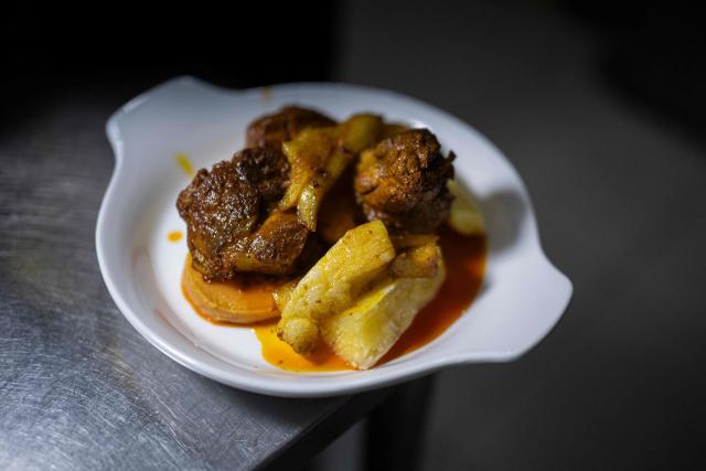 A plate of Chiclayo-style "Frito Chiclayano," said to have been one of Pope Leo XIV's favorite dishes, is displayed at a restaurant in Lima on September 15, 2026. Pope Leo XIV will visit Uruguay, Argentina and Peru from November 6 to 17, the Vatican said on August 5, in a return to the continent where the pontiff spent decades as a missionary. (Photo by Ernesto BENAVIDES / AFP)