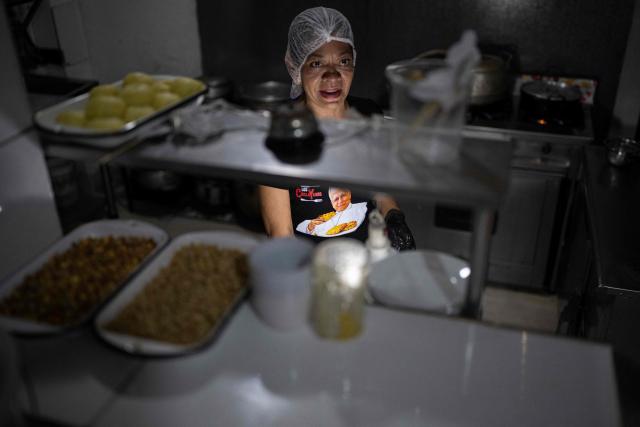 Ruth Garcia cooks a Chiclayo-style dish called "Frito Chiclayano," said to have been one of Pope Leo XIV's favorite dishes, at her restaurant in Lima on September 15, 2026. Pope Leo XIV will visit Uruguay, Argentina and Peru from November 6 to 17, the Vatican said on August 5, in a return to the continent where the pontiff spent decades as a missionary. (Photo by Ernesto BENAVIDES / AFP)