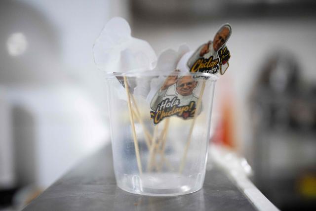 Decorative cocktail picks featuring images of Pope Leo XIV and the phrase "Hello Chiclayo" are displayed in a container at a restaurant specializing in traditional Chiclayo cuisine in Lima on September 15, 2026. Pope Leo XIV will visit Uruguay, Argentina and Peru from November 6 to 17, the Vatican said on August 5, in a return to the continent where the pontiff spent decades as a missionary. (Photo by Ernesto BENAVIDES / AFP)