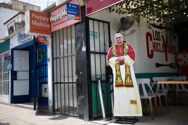 A life-size cutout depicting Pope Leo XIV stands outside a restaurant selling traditional Chiclayo food in Lima on September 15, 2026. Pope Leo XIV will visit Uruguay, Argentina and Peru from November 6 to 17, the Vatican said on August 5, in a return to the continent where the pontiff spent decades as a missionary. (Photo by Ernesto BENAVIDES / AFP)