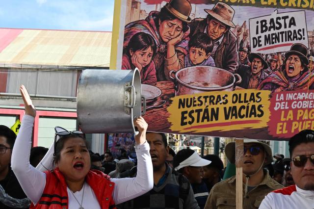 A demonstrator bangs a pot during a protest by education workers against the Bolivian government in La Paz on September 15, 2026. (Photo by Aizar RALDES / AFP)