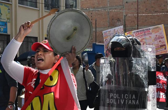 A demonstrator bangs a pot lid during a protest by education workers against the Bolivian government in La Paz on September 15, 2026. (Photo by Aizar RALDES / AFP)