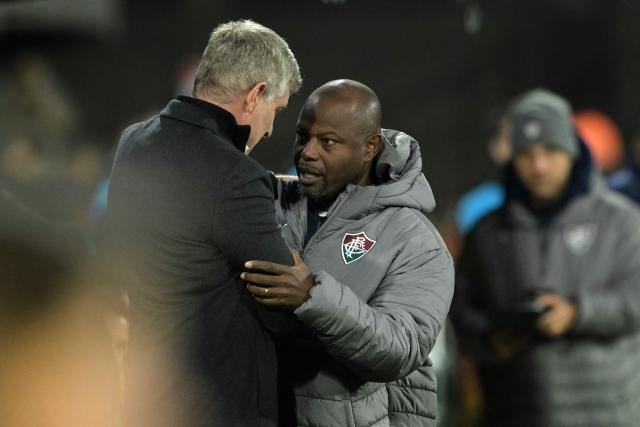Fluminense's head coach Marcao (R) and Platense's head coach Martin Palermo greet each other ahead of the Copa Libertadores quarter-final second leg football match between Argentina's Platense and Brazil's Fluminense at the Ciudad de Vicente Lopez stadium in Vicente Lopez, Buenos Aires province, Argentina on September 15, 2026. (Photo by JUAN MABROMATA / AFP)